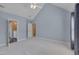 Bedroom with vaulted ceilings, carpeting, and ensuite bathroom at 3315 Swinford Ct, Raleigh, NC 27604