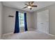 Spare bedroom features neutral carpet, closet and blue curtains for abundant natural light at 3315 Swinford Ct, Raleigh, NC 27604