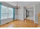 Bright dining room featuring hardwood floors, large window, and decorative chandelier at 3315 Swinford Ct, Raleigh, NC 27604