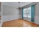 Elegant dining room showcasing hardwood floors, decorative chandelier, and large window at 3315 Swinford Ct, Raleigh, NC 27604