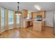 Bright kitchen boasts an island, stainless appliances, tile backsplash, and hardwood floors at 3315 Swinford Ct, Raleigh, NC 27604