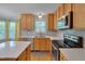 Updated kitchen with stainless appliances, white counters, and natural wood cabinets at 3315 Swinford Ct, Raleigh, NC 27604