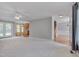 Open-concept living room leading to kitchen and dining areas, featuring plush carpet at 3315 Swinford Ct, Raleigh, NC 27604