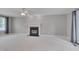 Large living room featuring fireplace, plush carpet, and large windows for natural light at 3315 Swinford Ct, Raleigh, NC 27604