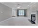 Bright living room with plush carpet, fireplace, and large window offering ample natural light at 3315 Swinford Ct, Raleigh, NC 27604