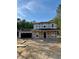 New home construction showcasing the home's framing with a covered porch and two car garage at 337 Green Pines Estates Dr, Kenly, NC 27542