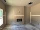 A blank canvas room showcasing a fireplace and natural light from a window at 337 Green Pines Estates Dr, Kenly, NC 27542