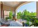 Open-air balcony with seating and views of surrounding trees and parking area at 340 Allister Dr # 201, Raleigh, NC 27609