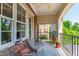 Inviting outdoor balcony featuring patio furniture, potted plants, and pleasant views of surrounding greenery at 340 Allister Dr # 201, Raleigh, NC 27609