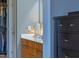 Bathroom vanity showcasing wood cabinetry, a white countertop, and a decorative lamp at 340 Allister Dr # 201, Raleigh, NC 27609