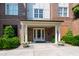 Welcoming brick building entrance with white columns, double doors, and manicured landscaping at 340 Allister Dr # 201, Raleigh, NC 27609