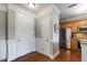 Entryway featuring hardwood floors, white doors, and kitchen view with stainless steel appliances at 340 Allister Dr # 201, Raleigh, NC 27609