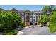 Exterior view of a well-maintained brick building with manicured landscaping and ample parking spaces at 340 Allister Dr # 201, Raleigh, NC 27609