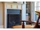 Traditional fireplace with white mantel and black fire screen, complemented by decorative shelving at 340 Allister Dr # 201, Raleigh, NC 27609