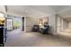 Hallway sitting area with chairs, artwork, and an outdoor seating area in the background at 340 Allister Dr # 201, Raleigh, NC 27609