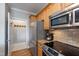 Updated kitchen with stainless steel appliances, granite counters and adjacent pantry and laundry area at 340 Allister Dr # 201, Raleigh, NC 27609