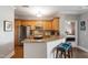 Well-lit kitchen featuring stainless steel appliances, wooden cabinets, and a granite breakfast bar with seating at 340 Allister Dr # 201, Raleigh, NC 27609