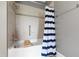 Shower and tub combination with tiled walls, shower curtain, and grab bar for safety at 340 Allister Dr # 201, Raleigh, NC 27609