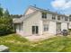 Exterior view of the home with a patio, green grass, and partial view of landscaping at 3601 Sugar Tree Pl, Durham, NC 27713