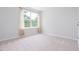 Cozy bedroom with plush carpet, a window with tan curtains, and natural light at 3601 Sugar Tree Pl, Durham, NC 27713