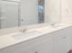 Bright bathroom features a double sink vanity with white cabinets and modern fixtures at 3604 Sorda Ct, Raleigh, NC 27610