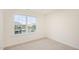 Bright bedroom with a large window offering neighborhood views and neutral carpeting at 3604 Sorda Ct, Raleigh, NC 27610