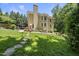 Spacious backyard with stone walkway, patio, and lush landscaping; great for entertaining at 3617 Carlow Ct, Raleigh, NC 27612