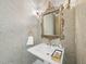 Charming powder room with a decorative mirror, elegant wallpaper, and designer fixtures at 3617 Carlow Ct, Raleigh, NC 27612
