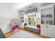 Cozy reading nook featuring built-in bookshelves, a window seat, and a comfy egg chair at 3617 Carlow Ct, Raleigh, NC 27612