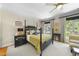 Spacious bedroom featuring four poster bed, neutral decor, carpet, ceiling fan, and bright windows at 3617 Carlow Ct, Raleigh, NC 27612