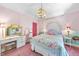Bright bedroom featuring colorful floral bedding, pink walls and plush pink carpeting at 3617 Carlow Ct, Raleigh, NC 27612