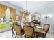 Bright dining room with large windows, chandelier, and seating for six is perfect for gatherings and entertaining at 3617 Carlow Ct, Raleigh, NC 27612
