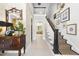 Inviting entryway features staircase, decorative mirror, console table, and views into other living areas, creating an elegant welcome at 3617 Carlow Ct, Raleigh, NC 27612