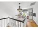 Upstairs landing area featuring hardwood floors, charming chandelier, and bonus room with fun built-ins at 3617 Carlow Ct, Raleigh, NC 27612