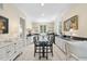 Well-lit kitchen with granite countertops, white cabinetry, and an adjacent dining area at 3617 Carlow Ct, Raleigh, NC 27612