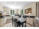 Well-lit kitchen with white cabinetry, granite countertops, and a breakfast table at 3617 Carlow Ct, Raleigh, NC 27612