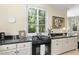 Bright kitchen featuring a granite countertop, white cabinets, and stainless steel appliances at 3617 Carlow Ct, Raleigh, NC 27612
