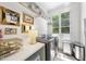 Bright laundry room features modern washer/dryer, built-in shelving, desk area, and natural light from large window at 3617 Carlow Ct, Raleigh, NC 27612