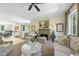 Sun-filled living room with a fireplace, elegant decor, and seamless flow to the dining area at 3617 Carlow Ct, Raleigh, NC 27612