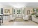 Stylish living room with large windows, a cozy seating area, and an adjacent dining room at 3617 Carlow Ct, Raleigh, NC 27612