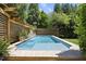 Sparkling pool with a serene waterfall feature, surrounded by lush landscaping at 3617 Carlow Ct, Raleigh, NC 27612