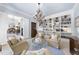 Airy sitting room with a full bookcase and decorative chandelier adjoins to other rooms, enhancing the home's flow and charm at 3617 Carlow Ct, Raleigh, NC 27612