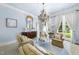 Elegant sitting room with chandelier, large windows, and comfortable seating creates a refined and inviting atmosphere at 3617 Carlow Ct, Raleigh, NC 27612