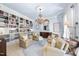 Refined sitting room featuring a full bookcase, elegant chandelier, and plush seating for a cozy and sophisticated ambiance at 3617 Carlow Ct, Raleigh, NC 27612