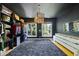 Spacious walk-in closet with dark ceiling, stylish hanging light, built-in shelving, and windows for natural light at 3617 Carlow Ct, Raleigh, NC 27612