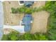 An aerial view shows a home with a long drive, spacious lawn, and surrounded by lush trees at 380 Pilot Ridge Rd, Zebulon, NC 27597