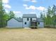 Back of the home featuring grey siding, patio, and a screened in porch at 380 Pilot Ridge Rd, Zebulon, NC 27597