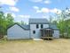 Backyard view of the home with a cozy screened-in porch and grey siding at 380 Pilot Ridge Rd, Zebulon, NC 27597