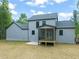 Back of the home featuring grey siding, a patio, and a screened in porch at 380 Pilot Ridge Rd, Zebulon, NC 27597