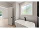 Bathroom featuring a soaking tub, sleek black fixtures and a luxurious tiled shower at 380 Pilot Ridge Rd, Zebulon, NC 27597